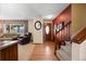 Inviting foyer with hardwood floors, staircase, and a view into the living room, creating a warm entrance at 2160 S Flower St, Lakewood, CO 80227