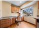 This kitchen desk includes overhead cabinets, a large window, and light-colored countertops at 2160 S Flower St, Lakewood, CO 80227