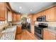 Bright kitchen featuring hardwood floors, light-colored countertops, and stainless steel appliances at 2160 S Flower St, Lakewood, CO 80227