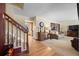 View of foyer leading into a spacious living room featuring hardwood floors and an adjacent staircase at 2160 S Flower St, Lakewood, CO 80227