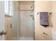 Bright bathroom showcasing a tiled shower with glass doors and towel rack at 2160 S Flower St, Lakewood, CO 80227