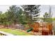 Expansive backyard featuring a wooden deck with a slide, perfect for outdoor entertainment and Gathering fun at 6278 E Euclid Ave, Centennial, CO 80111