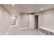 Finished basement area with neutral carpet, recessed lighting, storage, and access to the stairs at 6278 E Euclid Ave, Centennial, CO 80111