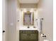 Stylish bathroom featuring a wood-framed mirror and modern olive green vanity at 6278 E Euclid Ave, Centennial, CO 80111