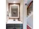 Charming powder room featuring a decorative mirror, modern sink, and stylish accents at 6278 E Euclid Ave, Centennial, CO 80111