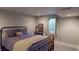 Bedroom showcasing an iron bed frame, a window for natural light, and neutral-colored walls at 6278 E Euclid Ave, Centennial, CO 80111