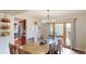 Inviting dining area with wooden table set and decorative light fixture, flowing into a well-lit kitchen at 6278 E Euclid Ave, Centennial, CO 80111