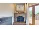 Detailed view of a fireplace, and a set of double doors leading to a private deck at 6278 E Euclid Ave, Centennial, CO 80111