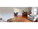 Bright living room featuring hardwood floors, piano, comfortable seating, and plenty of natural light at 6278 E Euclid Ave, Centennial, CO 80111