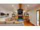 Cozy living room with a fireplace, beamed ceilings, and hardwood floors at 6278 E Euclid Ave, Centennial, CO 80111