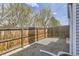Small gravel backyard with a wooden fence and partial concrete slab at 12332 Colorado Blvd # 30, Thornton, CO 80241