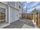 Pea gravel backyard, fenced in, with access door and siding on the home at 12332 Colorado Blvd # 30, Thornton, CO 80241