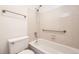 Clean bathroom with a tub and shower combination, grab bars, and neutral tiling at 12332 Colorado Blvd # 30, Thornton, CO 80241