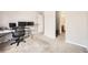 Bedroom featuring neutral carpeting, dual monitors, and access to a bathroom at 12332 Colorado Blvd # 30, Thornton, CO 80241