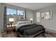 Serene staged bedroom with a window view, neutral decor, and modern lighting at 12332 Colorado Blvd # 30, Thornton, CO 80241