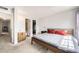Comfortable bedroom featuring neutral colors, a bed, and a view into the bathroom and closet at 12332 Colorado Blvd # 30, Thornton, CO 80241