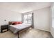 Bright bedroom with a large window, gray bedding, and modern decor at 12332 Colorado Blvd # 30, Thornton, CO 80241