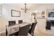 Dining area adjacent to an open kitchen, featuring a stylish chandelier at 12332 Colorado Blvd # 30, Thornton, CO 80241