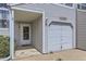Close-up view of a townhouse showcasing the entrance, garage, and address at 12332 Colorado Blvd # 30, Thornton, CO 80241