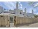 Exterior view of the home, showing the siding, fence, and small back yard at 12332 Colorado Blvd # 30, Thornton, CO 80241