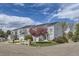 Inviting townhouse complex with well-manicured landscaping and a blooming tree at 12332 Colorado Blvd # 30, Thornton, CO 80241