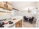 Open-concept kitchen with a view into the dining area and modern lighting fixture at 12332 Colorado Blvd # 30, Thornton, CO 80241