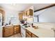 Bright kitchen area with wood cabinets, white countertops, and a view of the yard at 12332 Colorado Blvd # 30, Thornton, CO 80241