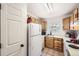 Efficient kitchen layout with oak cabinets, a window above the sink, and white appliances at 12332 Colorado Blvd # 30, Thornton, CO 80241