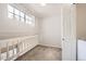 Carpeted loft space with a window, white railing, and a neutral color palette at 12332 Colorado Blvd # 30, Thornton, CO 80241
