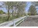 Paved walking path with a white fence, trees, and greenery on either side at 12332 Colorado Blvd # 30, Thornton, CO 80241