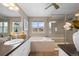 Bright primary bathroom featuring glass shower, soaking tub, and dual sink vanity at 14284 W 88Th Dr # B, Arvada, CO 80005