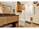 Stylish bathroom with wood vanity, modern fixtures, and a glass-enclosed walk-in shower at 603 Inca St # 520, Denver, CO 80204