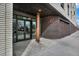 Apartment entrance with brickwork, copper accents, and glass doors leading to the interior at 603 Inca St # 520, Denver, CO 80204