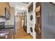 Hallway with hardwood floors, laundry, and kitchen with stainless appliances at 603 Inca St # 520, Denver, CO 80204