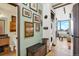 Hallway with hardwood floors leading to the living room with modern kitchen at 603 Inca St # 520, Denver, CO 80204