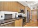 Modern kitchen with stainless steel appliances, sleek countertops, and wood cabinetry at 603 Inca St # 520, Denver, CO 80204