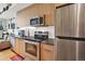 Updated kitchen featuring stainless steel appliances, sleek countertops, and wood cabinets at 603 Inca St # 520, Denver, CO 80204