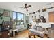 Cozy living room with hardwood floors, large windows with city views, and unique decor at 603 Inca St # 520, Denver, CO 80204