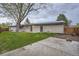 The backyard features green grass, a patio, solar panels, and privacy fence at 10698 W 26Th Ave, Lakewood, CO 80215