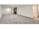 Large, open finished basement with neutral carpet, recessed lighting, and a brick fireplace at 10698 W 26Th Ave, Lakewood, CO 80215
