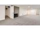 Spacious finished basement with neutral carpet, white walls, and a cozy fireplace at 10698 W 26Th Ave, Lakewood, CO 80215