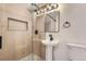 Updated bathroom features a modern vanity, framed mirror and tiled glass shower at 10698 W 26Th Ave, Lakewood, CO 80215