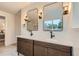 Stylish bathroom with double sink vanity, modern mirrors and lighting, and white marble counter at 10698 W 26Th Ave, Lakewood, CO 80215