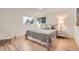 Bright bedroom features hardwood floors, a large window, neutral walls, and stylish bedding at 10698 W 26Th Ave, Lakewood, CO 80215