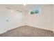 This bedroom has soft gray carpet, a window with natural light, and large closet at 10698 W 26Th Ave, Lakewood, CO 80215