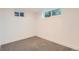 This bedroom offers soft gray carpet and bright natural light from two windows at 10698 W 26Th Ave, Lakewood, CO 80215