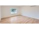 Empty bedroom with hardwood floors, white trim, a single window, and neutral walls at 10698 W 26Th Ave, Lakewood, CO 80215