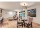 Open dining space with modern lighting and views of the living area and exterior at 10698 W 26Th Ave, Lakewood, CO 80215