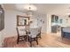 Cozy dining area with a glass table, modern chandelier, and view into the kitchen at 10698 W 26Th Ave, Lakewood, CO 80215