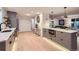 Well-lit kitchen with stylish gray cabinetry, stainless appliances, and a spacious island at 10698 W 26Th Ave, Lakewood, CO 80215